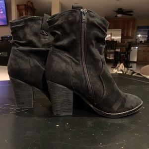 Black zip up ankle boots by Zigisoho